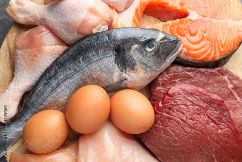 Cuadro en lienzo Different types of fresh raw meat, fish and eggs on table, top view