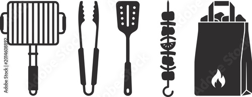 Black barbecue grill and cooking utensils
