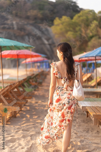 Woman in dress on the beach.