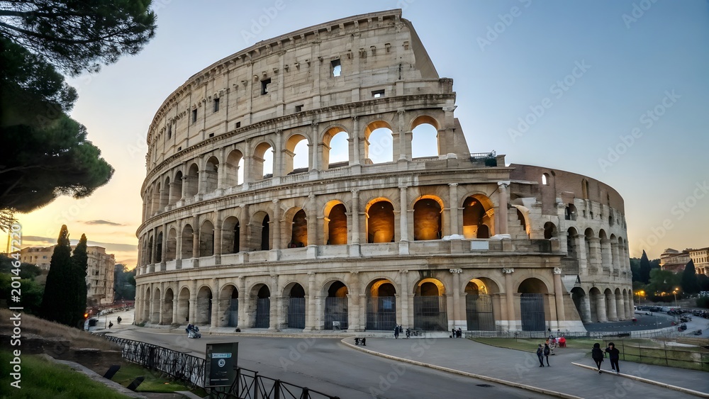 Fototapeta premium Ancient Roman Colosseum at dusk with warm lighting and tourists