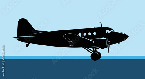 Photos Black silhouette of a twin-engine propeller aircraft flying over dark blue water