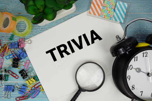 Canvastavla Trivia text on a paper surrounded by office supplies, a magnifying glass, and a