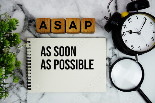 Konstfotografi ASAP As Soon As Possible text with alarm clock and magnifying glass on marble ba