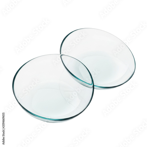 Two clear hydrogel contact lenses with subtle teal edges overlapping on transparent background with wet reflections, clinical vision technology atmosphere