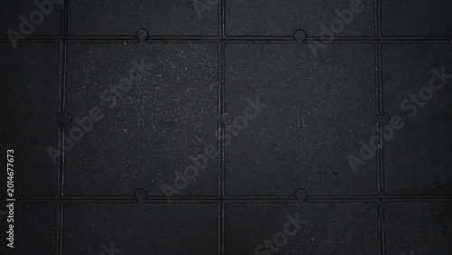 Konstfotografi Top view of black interlocking rubber floor tiles with industrial textured surfa