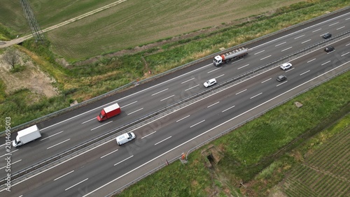 Highway Movement: An aerial perspective captures a bustling highway, a symphony of motion where cars and trucks traverse a multi-lane road. The image captures the essence of travel, industry.