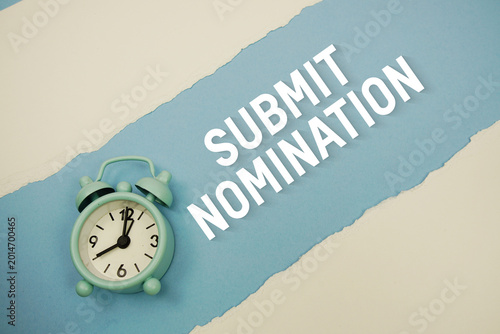 фотографія Submit Nomination with alarm clock on blue background