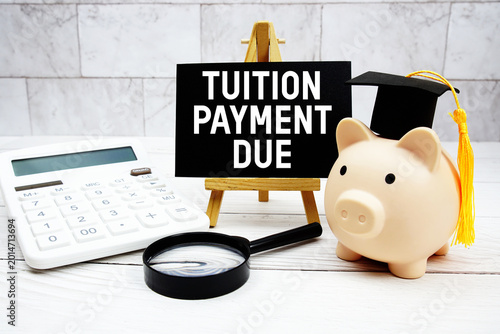Tuition Payment Due text with mortarboard, piggy bank, calculator, magnifying glass