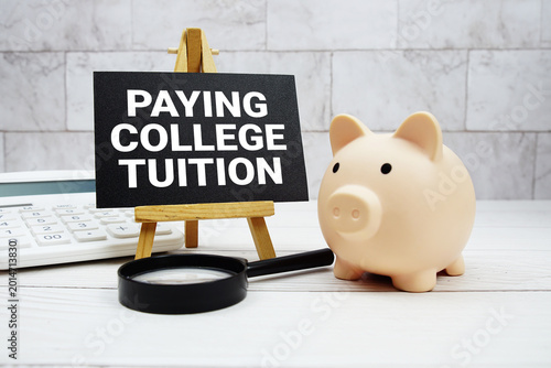 Photos Paying College Tuition text  with piggy bank, calculator and magnifying glass