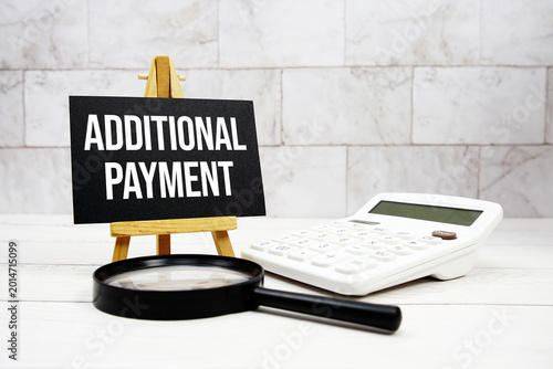 Fotografie Additional Payment text with calculator and magnifying glass