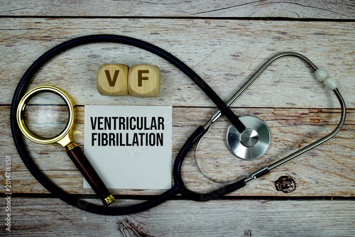 Tableau sur toile Ventricular Fibrillation (VF) text with stethoscope and magnifying glass on wood