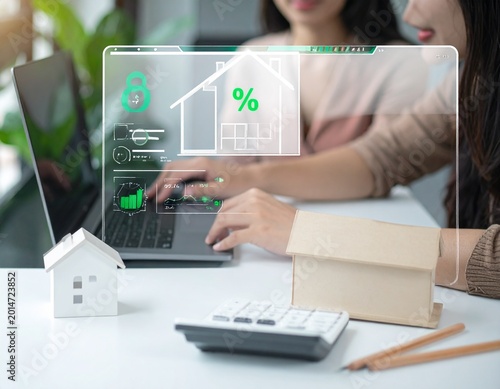 Businesswoman analyzing real estate data on laptop with transparent financial graphics overlay