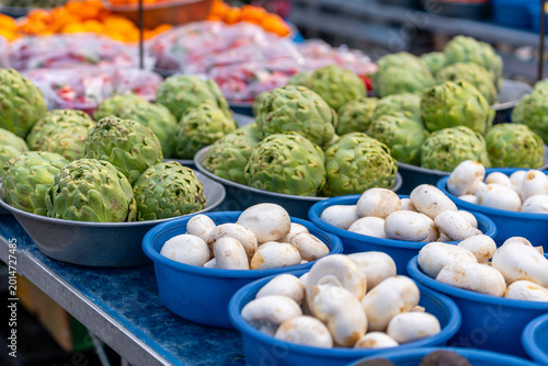 Fresh green artichokes in a market. Fruit and vegetable stand