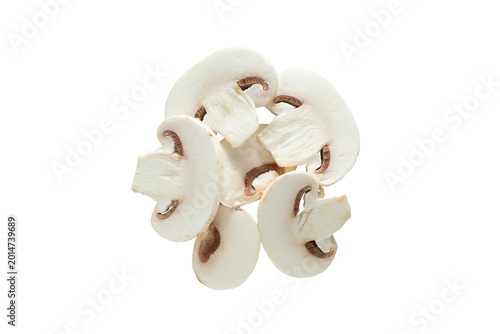 A top down view of a pile of sliced white button mushrooms, against a white background.
