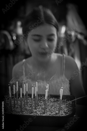 Teen Girl Celebrating 13th Birthday with Candles and Cake, Emotional Black and White Family Celebration, Bat Mitzvah Age, Happy Birthday Party Close Up