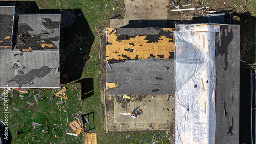 aerial view of residential neighborhood destruction after a tornado with damaged houses