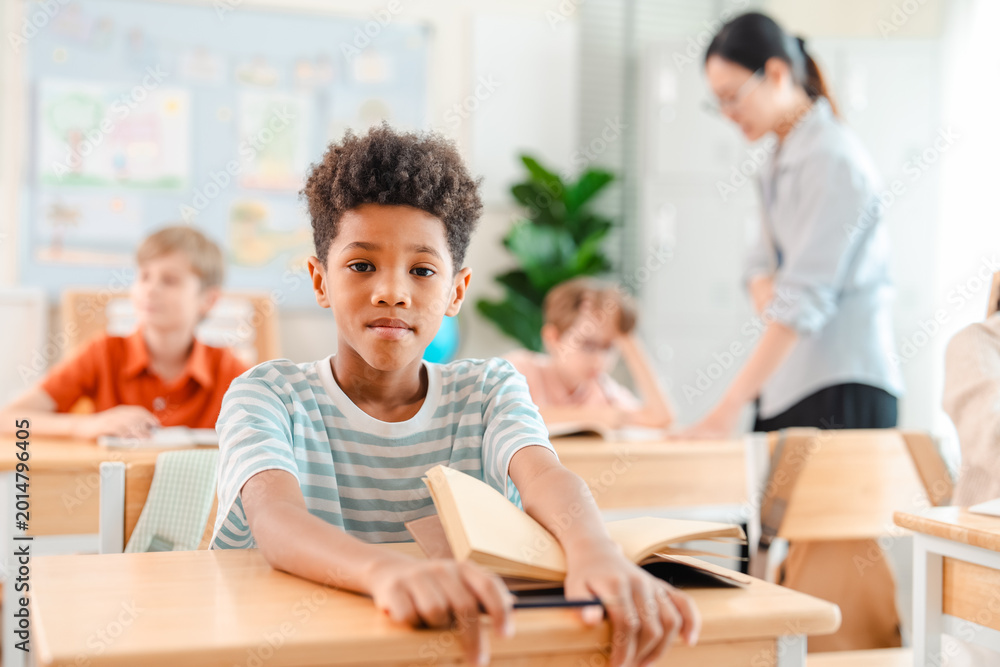 Obraz premium Back to school and education concept of school classroom boy student front view open book desk child education teacher primary school learning study