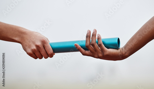Foto Running, baton and hands of people in relay race for competition, track event and challenge