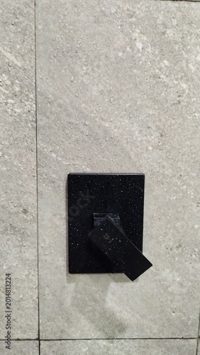 Modern Matte Black Shower Mixer Tap with Water Droplets on Granite Tile Wall