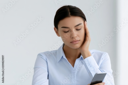 Person placing phone face down and closing eyes briefly at desk, digital boundary concept, sstkHealth