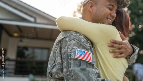 Fotografie A veteran returning home from battle to see his wife and loved one embraced with affection upon meeting her