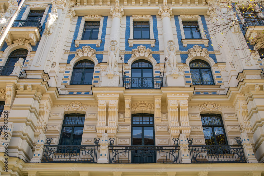 Fototapeta premium Ornate historic european facade with decorative windows and elegant classical architectural details