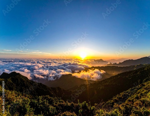 sunrise over cloud inversion above mountain range golden hour panoramic landscape