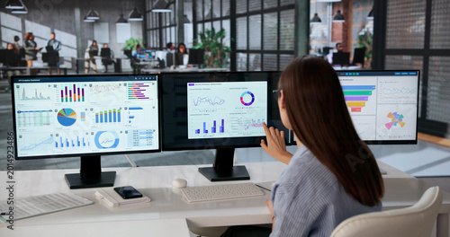 Cuadro en lienzo Young Female Data Analyst Studying Multiple Financial Dashboards