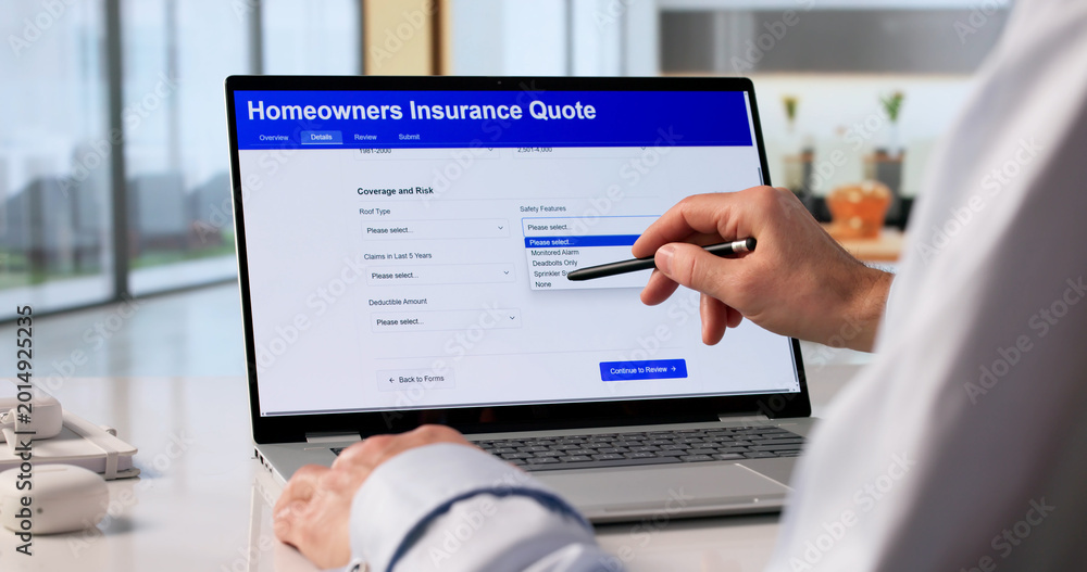 Fototapeta premium Man Reviewing Home Insurance Rates On Laptop