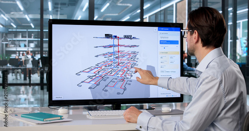 фотографія Male Mechanical Engineer Uses Touchscreen Computer
