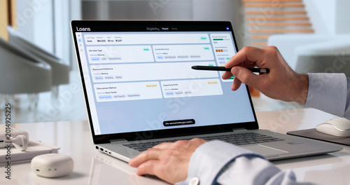 Photos Man Uses Laptop To Check Personal Loan Eligibility