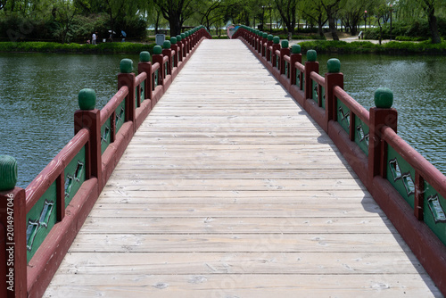 Symmetric Pathway on Gungnamji Wooden Bridge toward Lush Shore