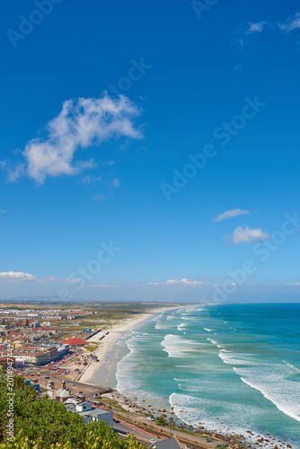 Foto Beach, city and blue sky with nature for outdoor travel, tourism or getaway resort with mockup space