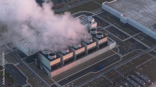 Cloud data center cooling system releasing steam at sunset