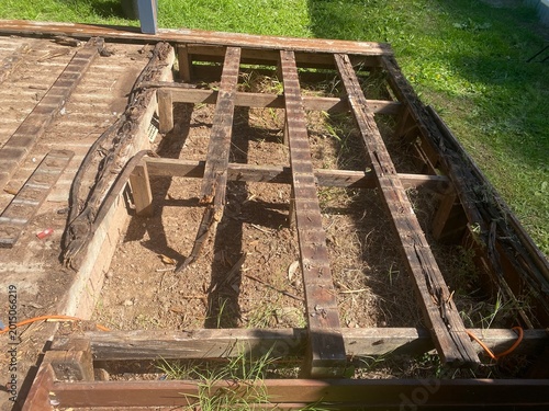 Rotted wood deck boards decayed timber caused by fungi thriving in damp conditions, represent a significant structural risk, house renovations project.