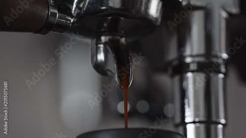 Slow motion espresso pour from single spout portafilter into black cup