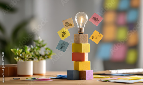 light bulb stands behind colorful wooden cubes