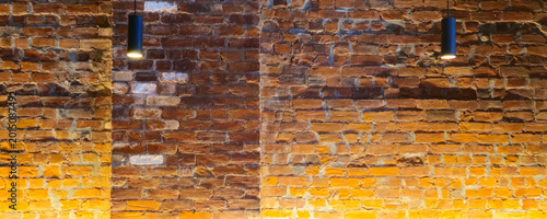 Cozy restaurant dining room with warm lighting, brick wall decor, wooden tables and pendant lights.