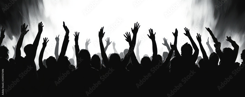 Obraz premium Backlit silhouetted crowd with raised hands and stage smoke under bright lights, cheering in energetic celebration and unity