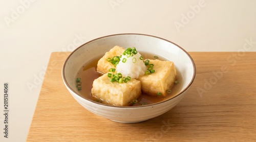 Deep-fried soft tofu in dashi broth topped with scallions and grated daikon