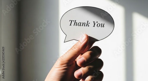 Hand Holding a Speech Bubble with Thank You Message.