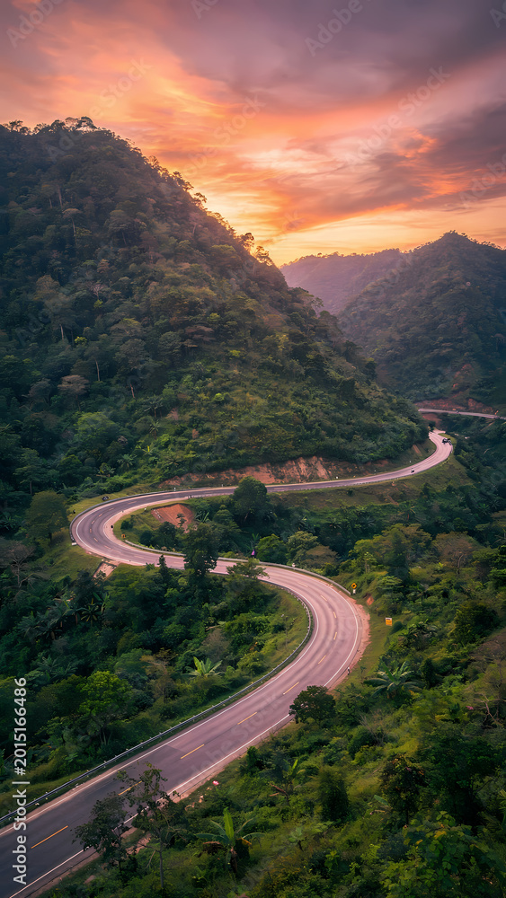 Fototapeta premium Scenic Mountain Road Through Green Valley Landscape