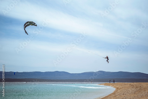 Golden Horn Beach, Brac Island, Croatia: Kitesurfer jumping in the air over the ocean