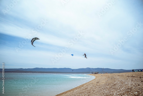 Golden Horn Beach, Brac Island, Croatia: Kitesurfer jumping over turquoise water near beach