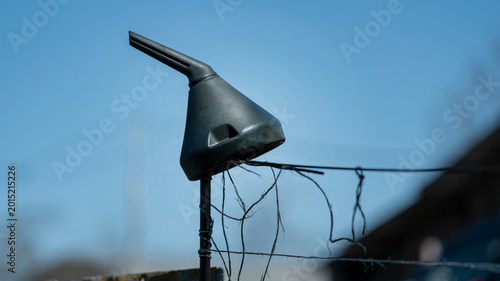 Cuadro en lienzo Repurposed plastic funnel attached to a fence with wires, representing concepts