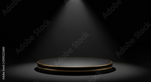 Empty black circular podium with gold trim under a spotlight