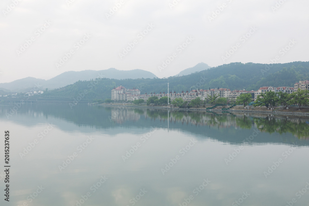 Fototapeta premium The city and its landscape in the morning mist and rain