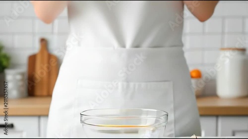 Cracking Raw Egg into Glass Bowl for Cooking and Baking Preparation