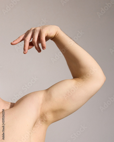 A man shows off his muscles, a real photo of people