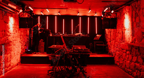Fotografie Red Lit Underground Music Club With DJ Stage Setup